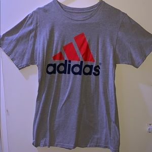 Adidas gray shirt with logo on the front.